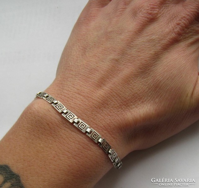 Silver bracelet with a tribal, openwork pattern