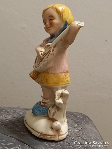 A little girl plays the guitar. Antique beautiful Altwien porcelain