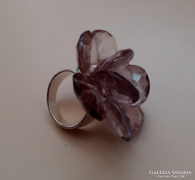 A silver-plated ring with a large head in the shape of a rose, in good condition