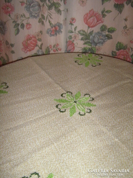 Light beige woven tablecloth embroidered with beautiful green