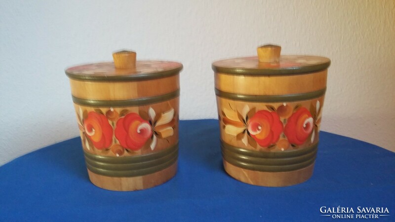 Two wooden cylindrical boxes with roofs painted with an old Russian folk flower pattern