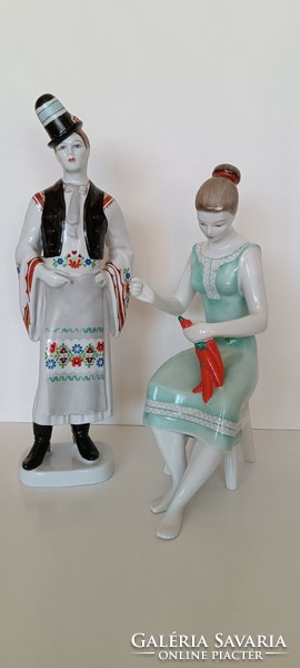 A porcelain boy in Hollóháza folk costume and a girl with a bell pepper