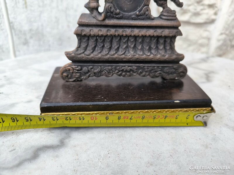 A beautiful figural bronze statue on a wooden base holding a pocket watch. Eastern Asian sculpture dancing figures