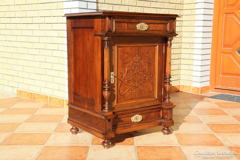 A tin German, richly carved chest of drawers