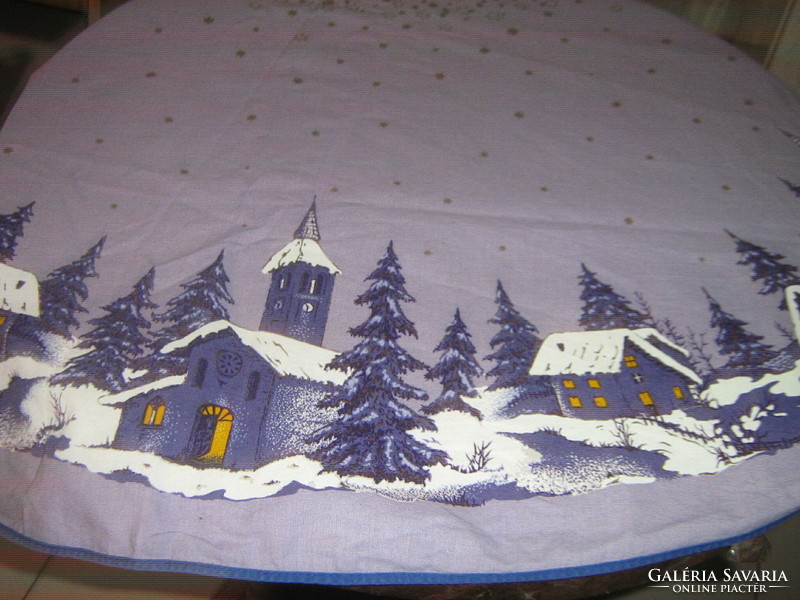 Beautiful winter huge oval tablecloth with fairytale snow houses with church and pine trees