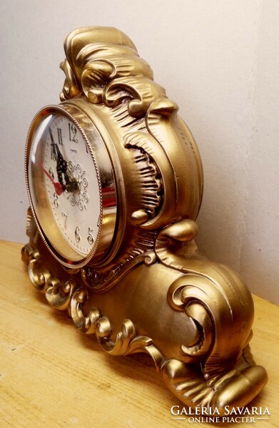 Baroque-style battery-operated table clock in a gold-plated vinyl housing, accurate and functional