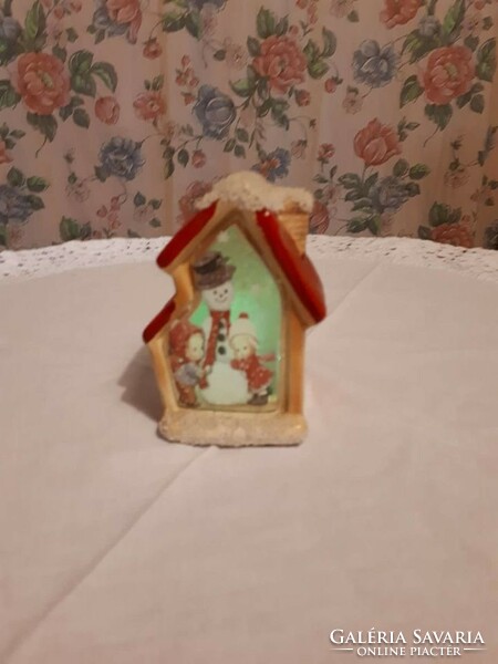 Christmas decoration in several colors, illuminated house, snowman, Santa Claus