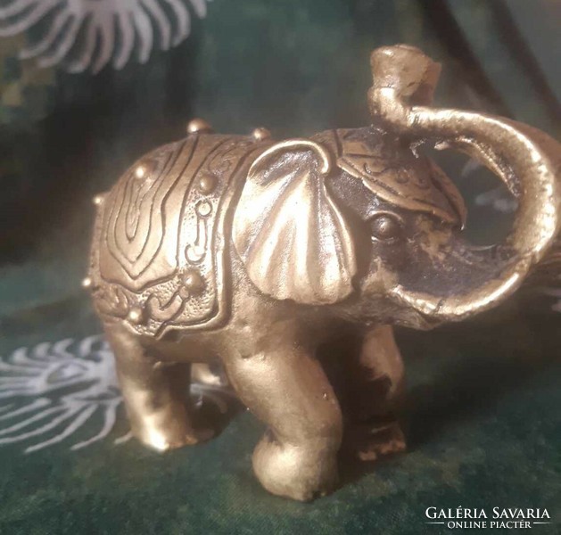 Golden elephant statue with an upturned trunk
