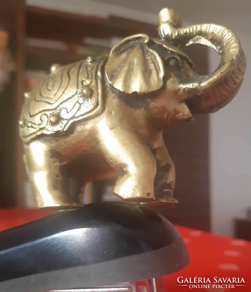 Golden elephant statue with an upturned trunk