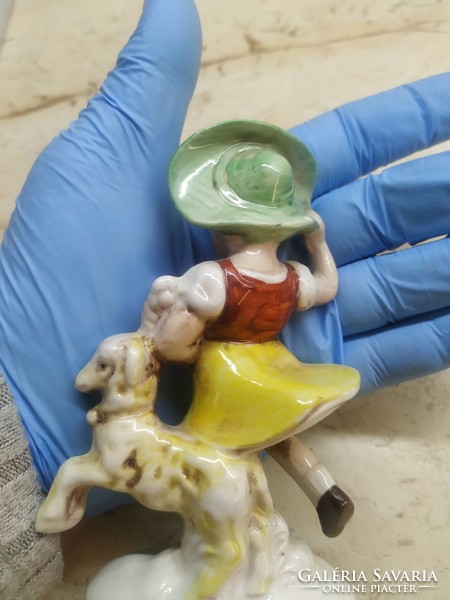 Little girl in a green hat with a toy statue! Antique porcelain statue, marked and numbered at the bottom for sale!
