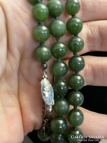 For sale is a truly antique jade necklace with original silver clasp and safety chain. Collector's item