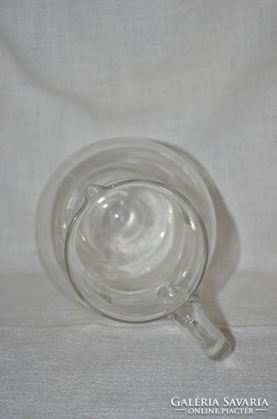 Broken glass jug with polished decoration