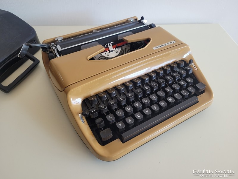 Old retro small pocket typewriter mid century typewriter in caramel color
