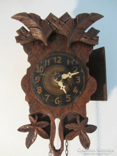Tiny, carved black forest clock