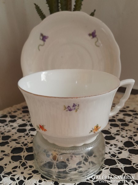 Zsolnay shield-stamped tea cup with a small flower pattern and leprechaun ears on the bottom