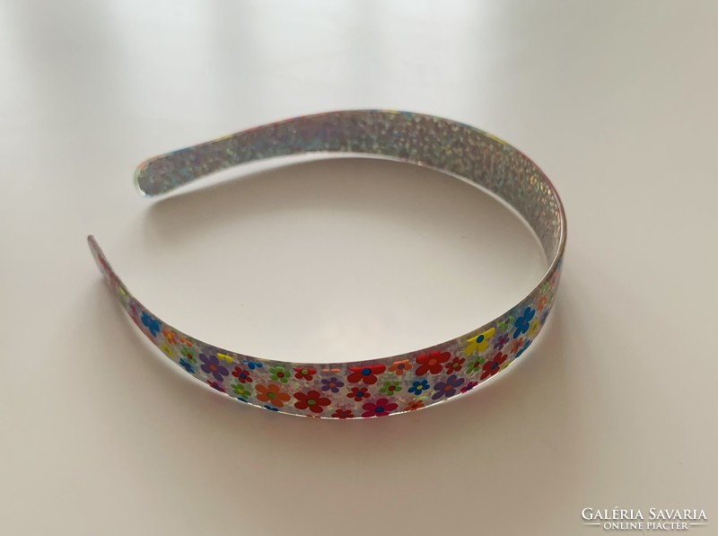 A special floral headband scatters the light like a prism