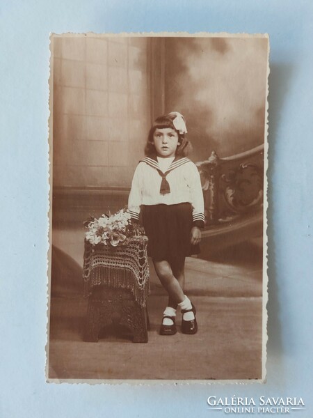 Old postcard photo of little girl in uniform