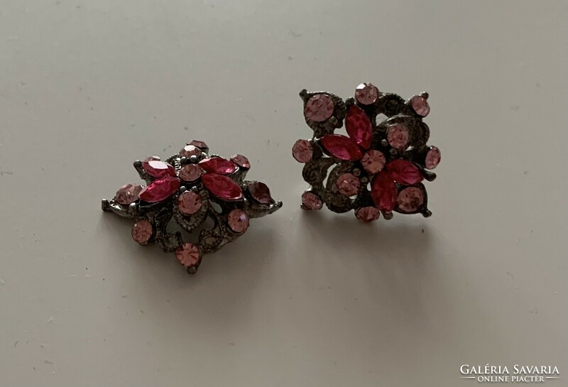 Silver colored metal clip earrings studded with pink colored stones