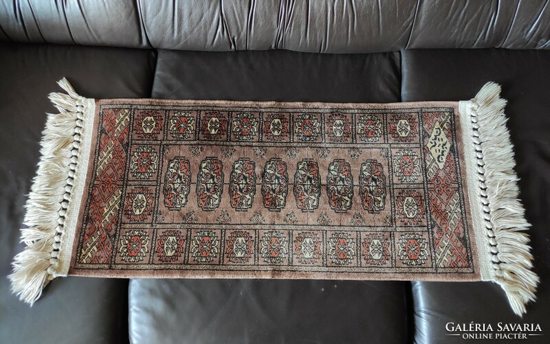 A small rug with a fringed Persian pattern from the legacy of the photographer 