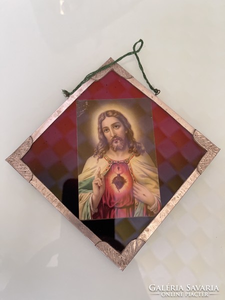 Old glass icon in a metal frame with metal decoration.