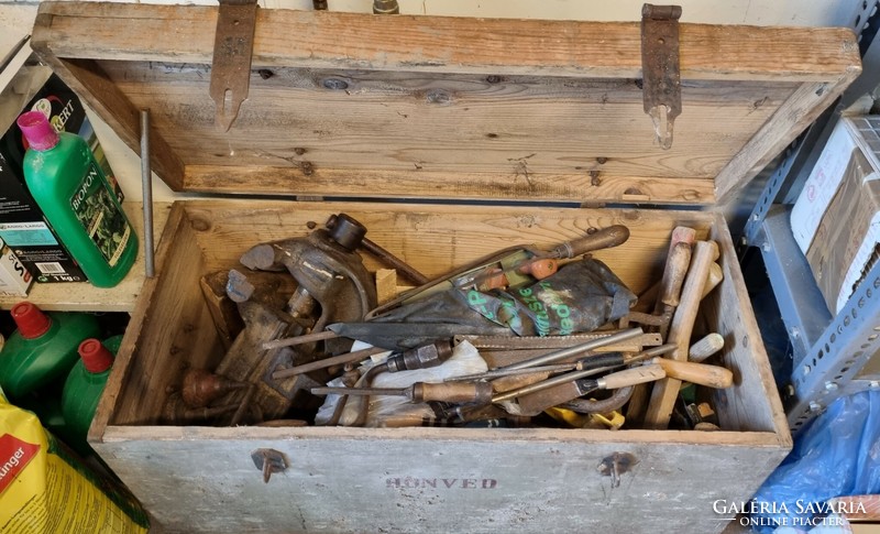 Old military tools in a wooden chest - giant vise, planers, hand drills, chisels, saws, axes, etc.