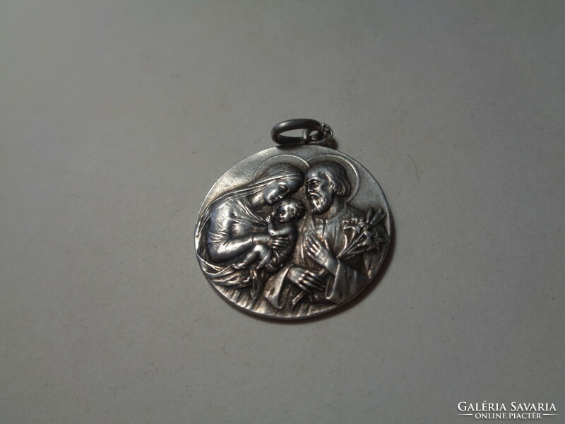 The Holy Family pendant, dated 1912. Made of silver, 25 mm in diameter