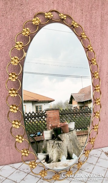 A modern art object. Gold-plated metal frame oval mirror in perfect condition