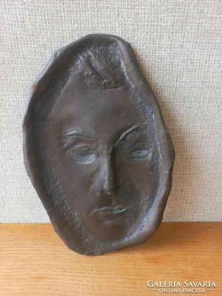 Retro or antique metal wall mask. Goldsmith's work