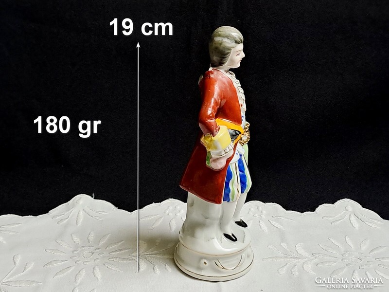2 marked porcelain figurines: a boy in baroque clothes and a girl with an umbrella