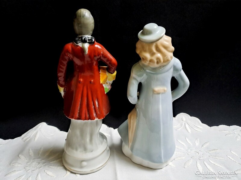 2 marked porcelain figurines: a boy in baroque clothes and a girl with an umbrella