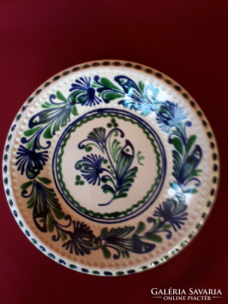 Floral wall plate painted in blue and green