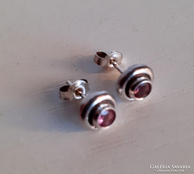 Marked 925 sterling silver stud earrings studded with a polished pink zirconia stone