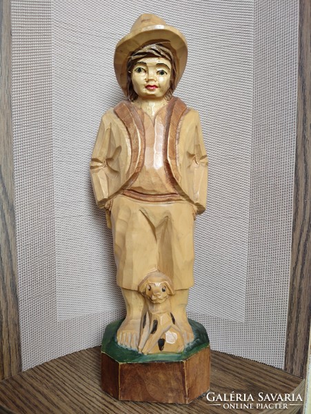 Large carved statue of a peasant boy with a puppy g. From the legacy of photographer Maxi