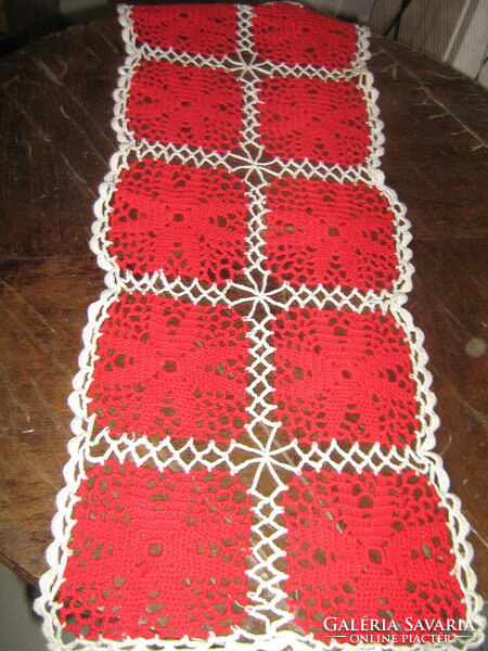 Beautiful hand-crocheted white and red tablecloth with a floral pattern