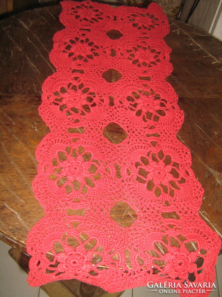 Beautiful hand-crocheted red tablecloth with a floral pattern