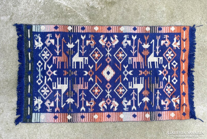 Hand-knotted Bulgarian rug made of blue dyed wool decorated with animals 123 x 66 cm
