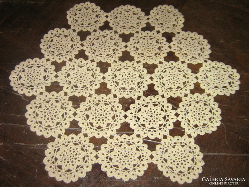Beautiful beige crocheted hexagonal antique lace tablecloth