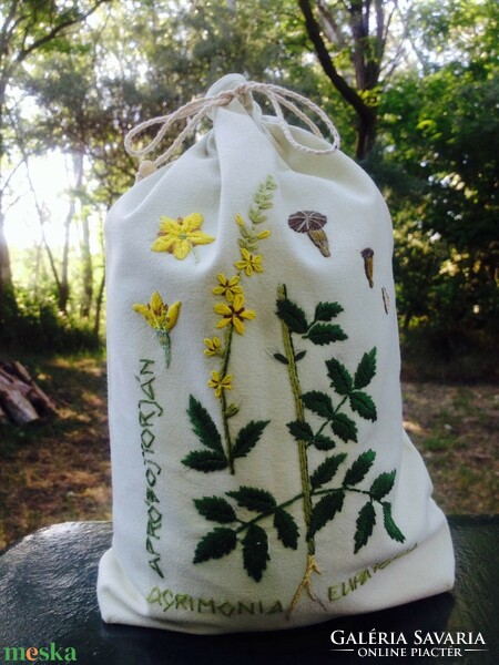 Embroidered herbal bag with a pattern on small tassels