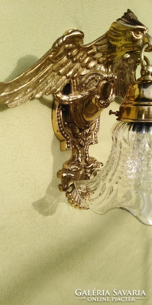 A large wall arm decorated with an eagle is for sale.