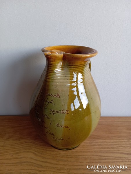 Folk ceramic jug with a biblical quote.
