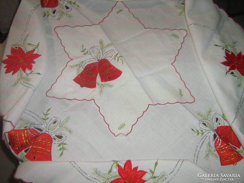 A charming Christmas tablecloth with sewn decorative floral bells and a star-shaped napkin