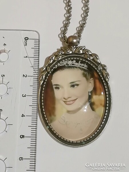 Long necklace with audry hepburn pendant.