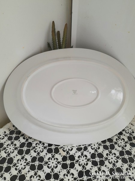 A large epiag serving bowl with a small flower pattern