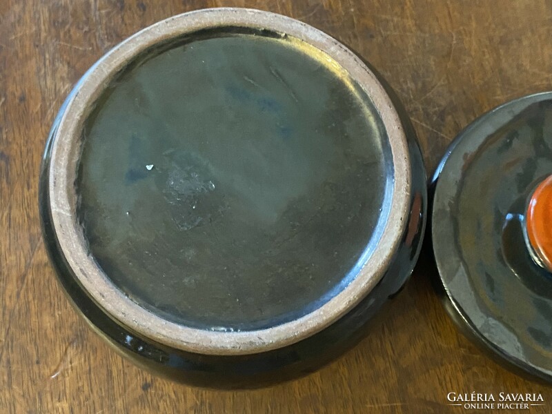 Gray round ceramic lidded jewelry holder bowl with orange tongs