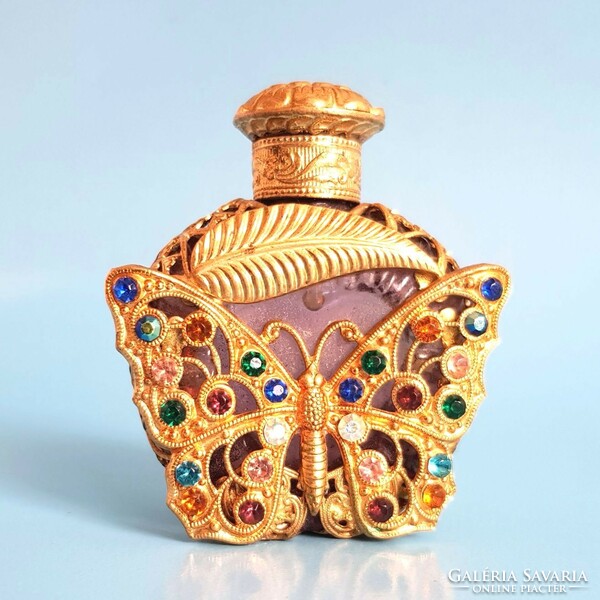 Beautiful perfumed cologne bottle embellished with a butterfly decoration