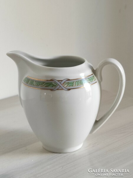 Graceful porcelain cream with a flowing green-gold Art Nouveau pattern