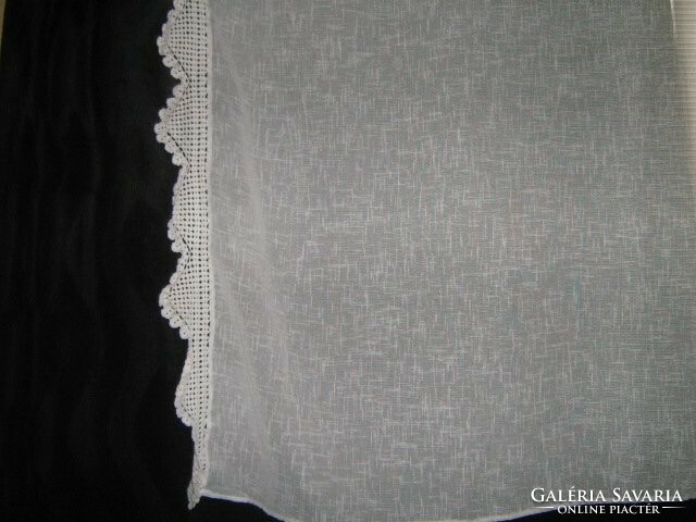 A beautiful pair of curtains with hand-crocheted edges
