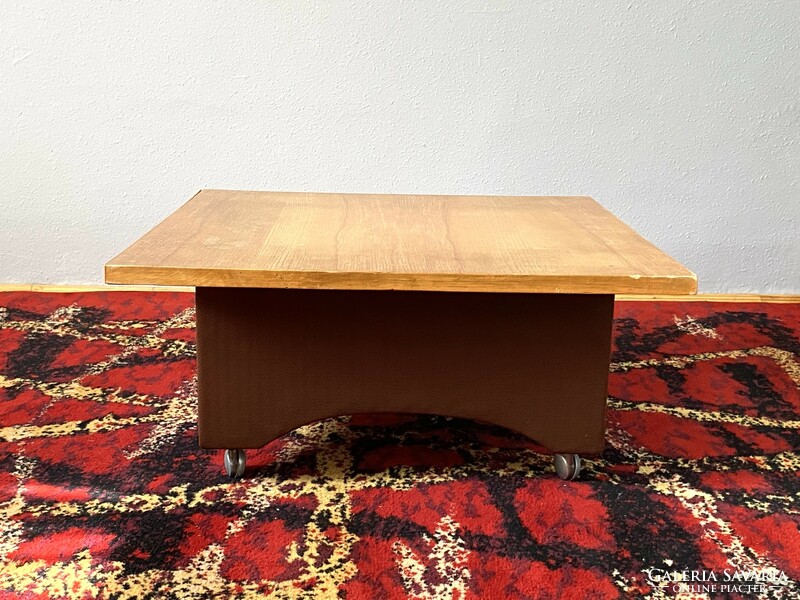 Rolling retro coffee table with a plush cover at the bottom