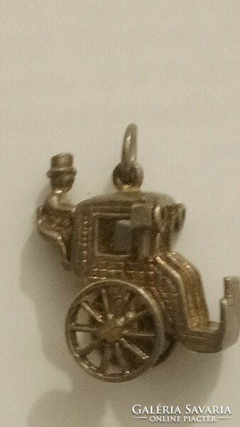 An antique silver carriage with a carriage shaped pendant, with traces of former gilding