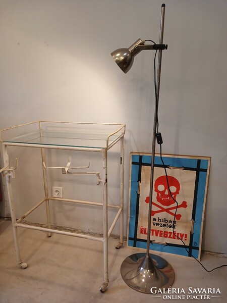 Old medical metal table on castors with fold-out tray holders